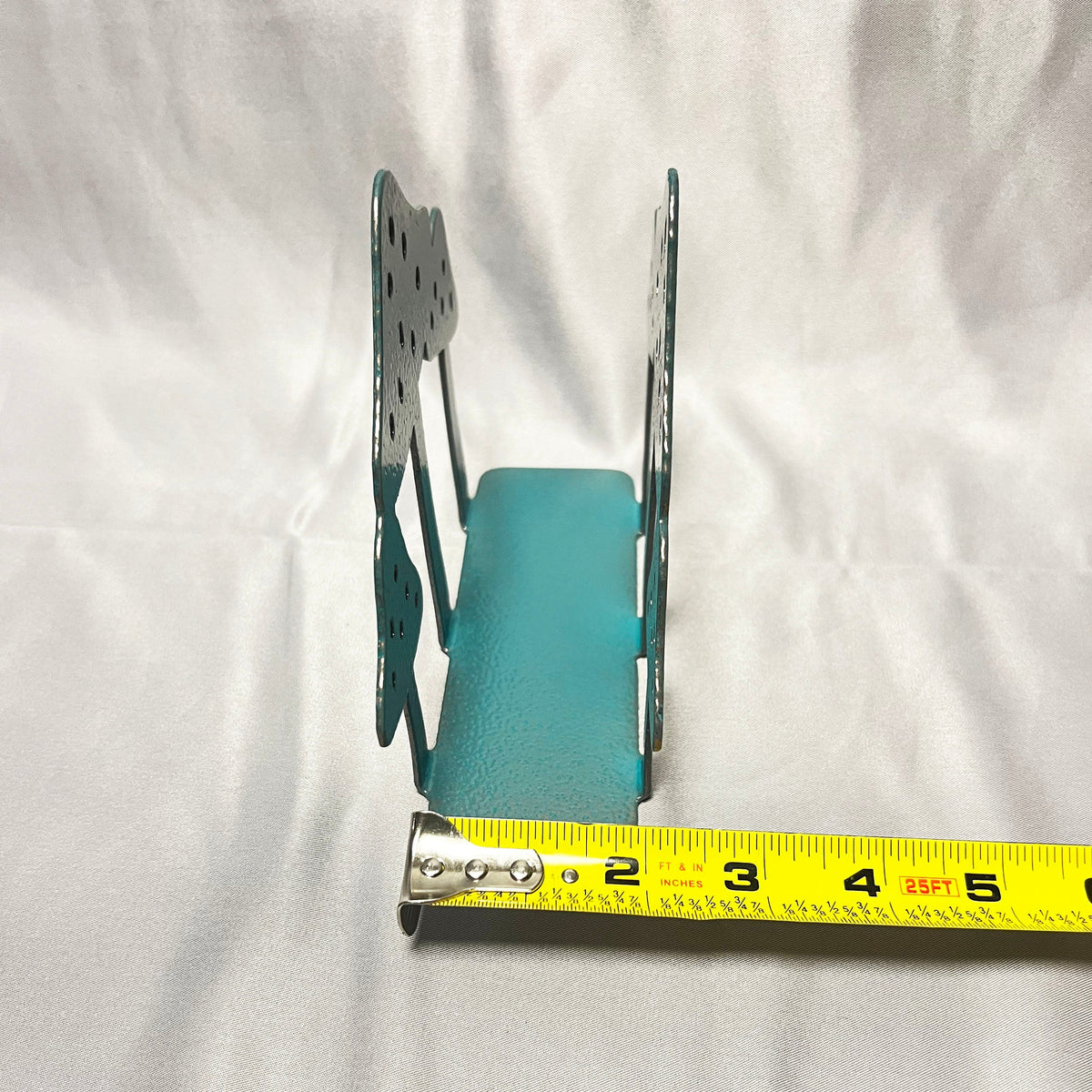Side view of mushroom napkin holder with measuring tape showing base depth