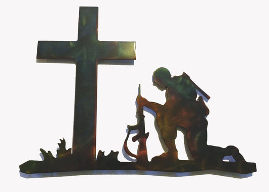 Soldier kneeling before a cross metal wall art with hand-finished patina.