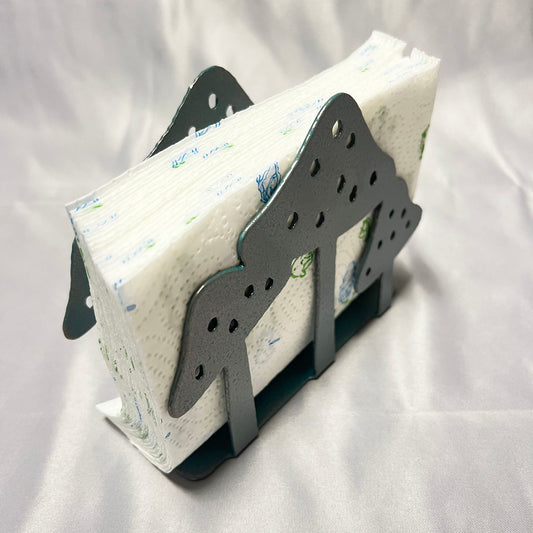 Angled view of metal mushroom napkin holder filled with white paper napkins