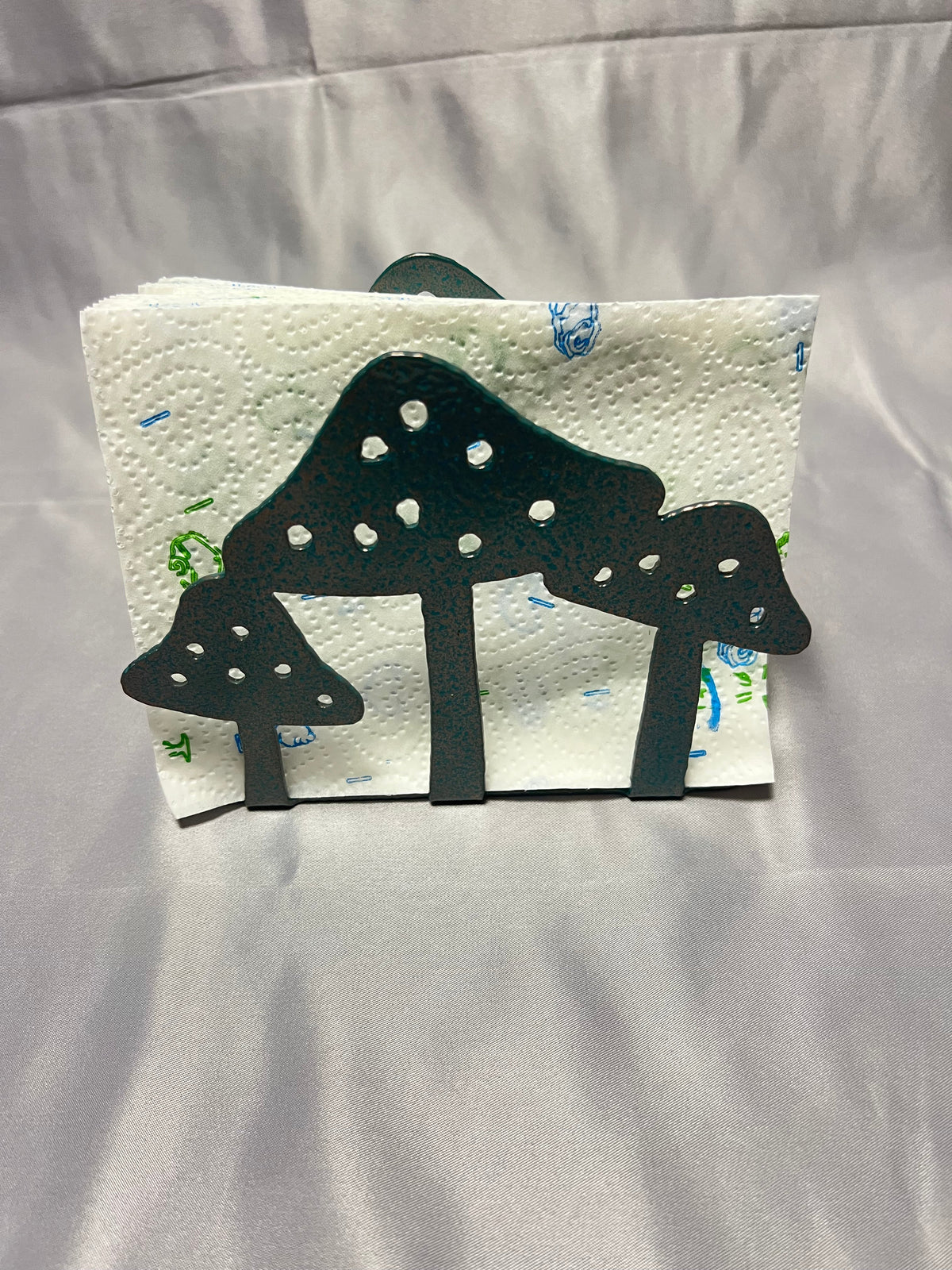 Handmade mushroom napkin holder shown with paper napkins for everyday kitchen use