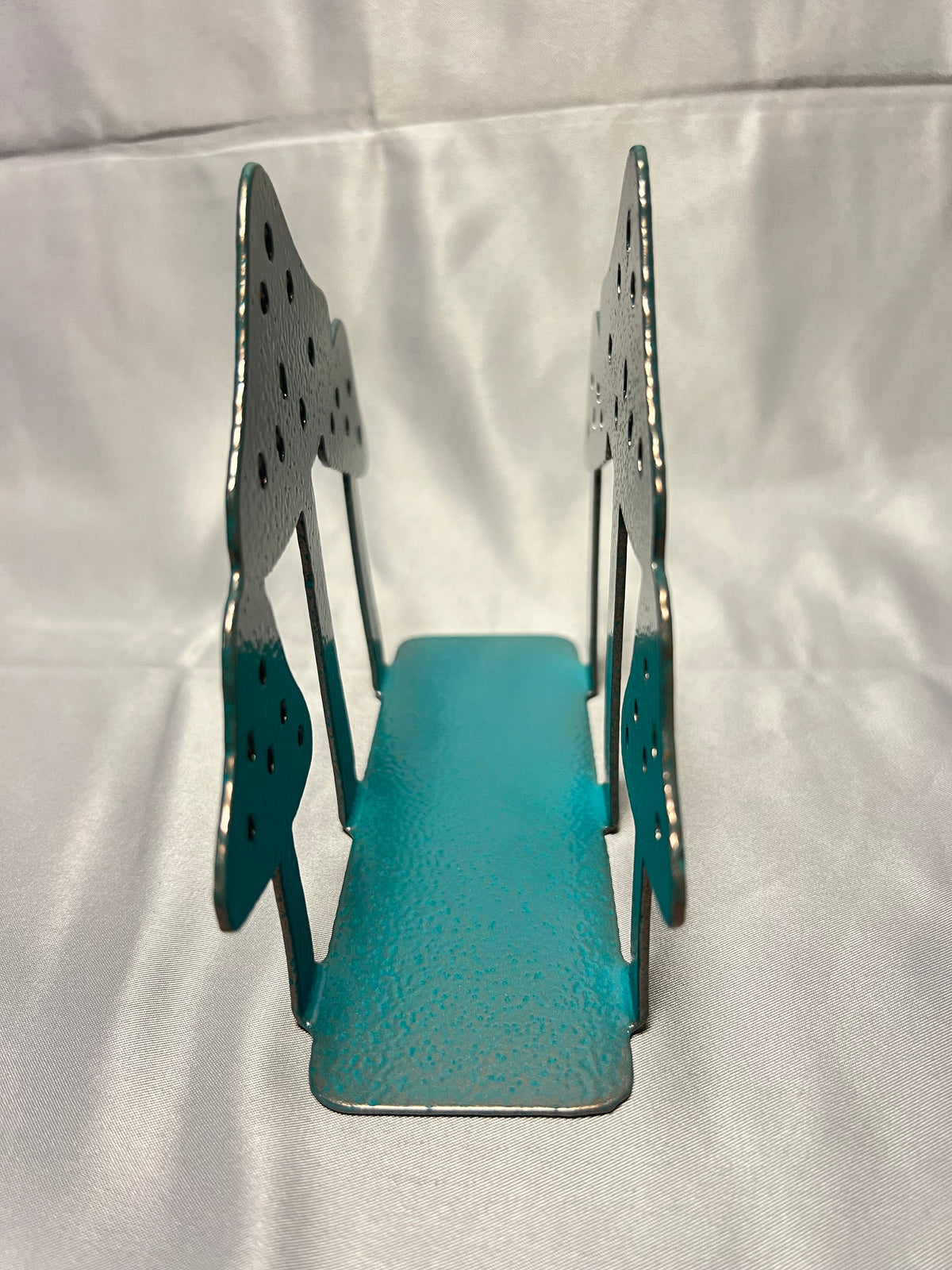 End view of metal mushroom napkin holder showing open center for paper napkins