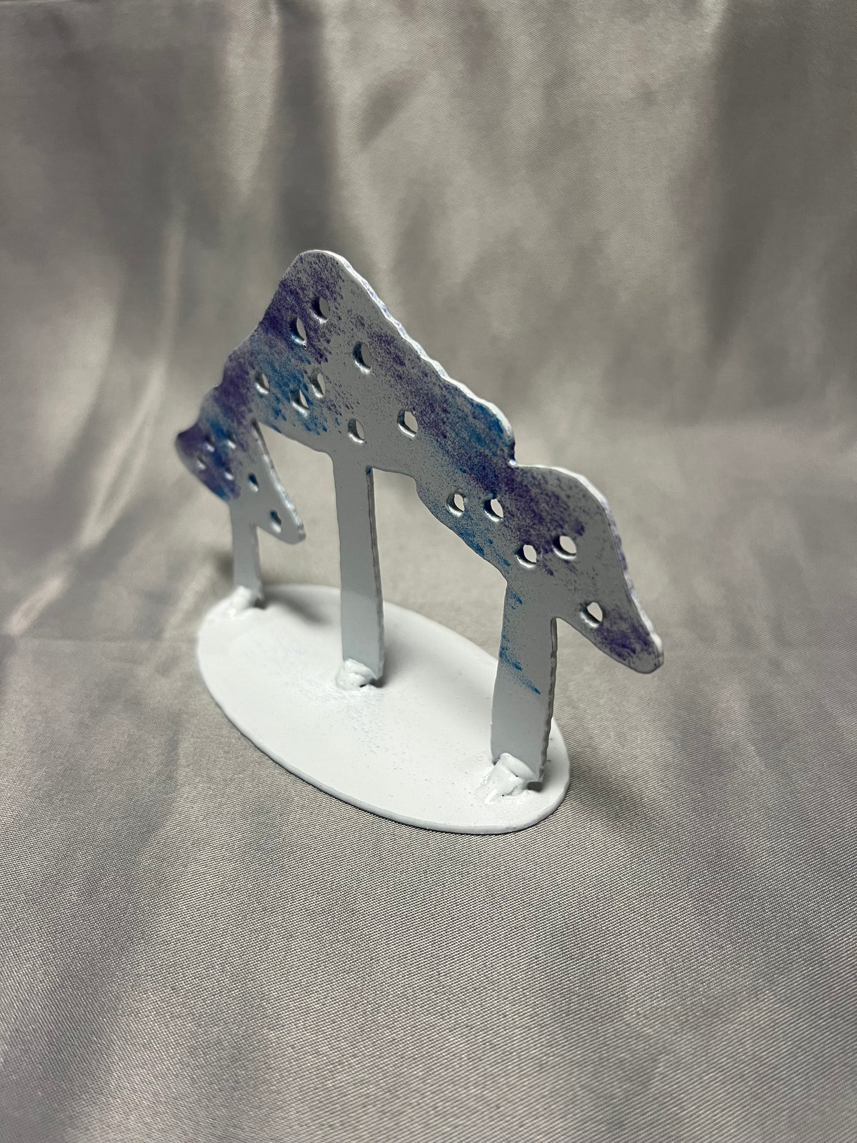 Angled view of colorful freestanding steel mushroom figurine