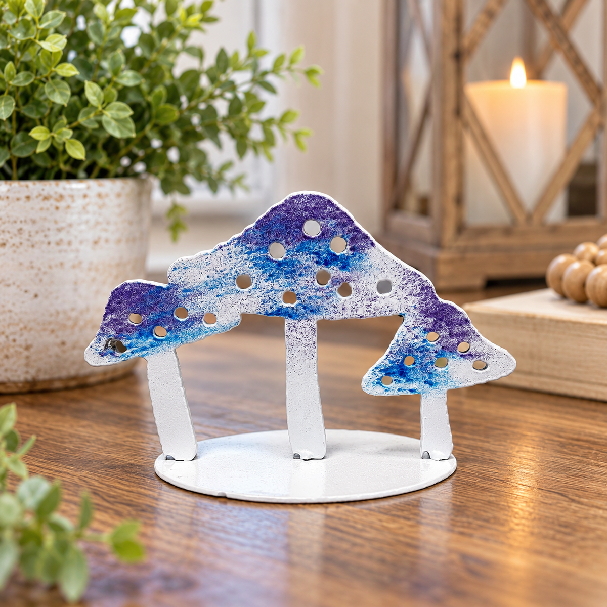 Handmade metal mushroom stand displayed on a wood table in cozy home decor