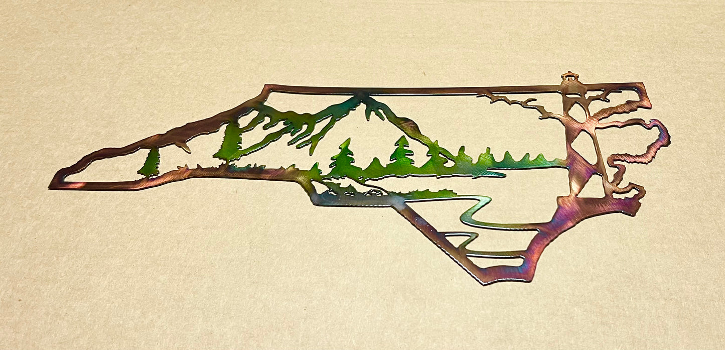 Metal wall art of a bear and trees in the shape of North Carolina on a beige background