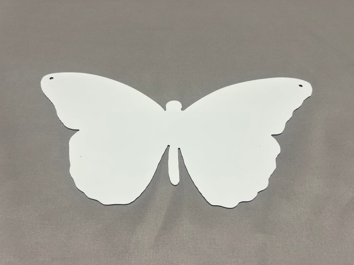 Back view of butterfly-shaped metal wall decor showing the smooth white finished backside.