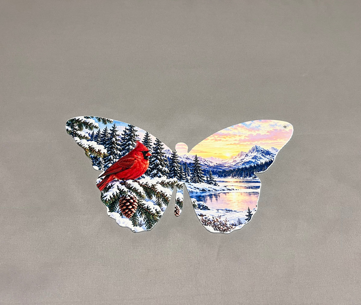 Angled view of UV printed cardinal butterfly metal decor showing the colorful winter mountain and snowy forest artwork.