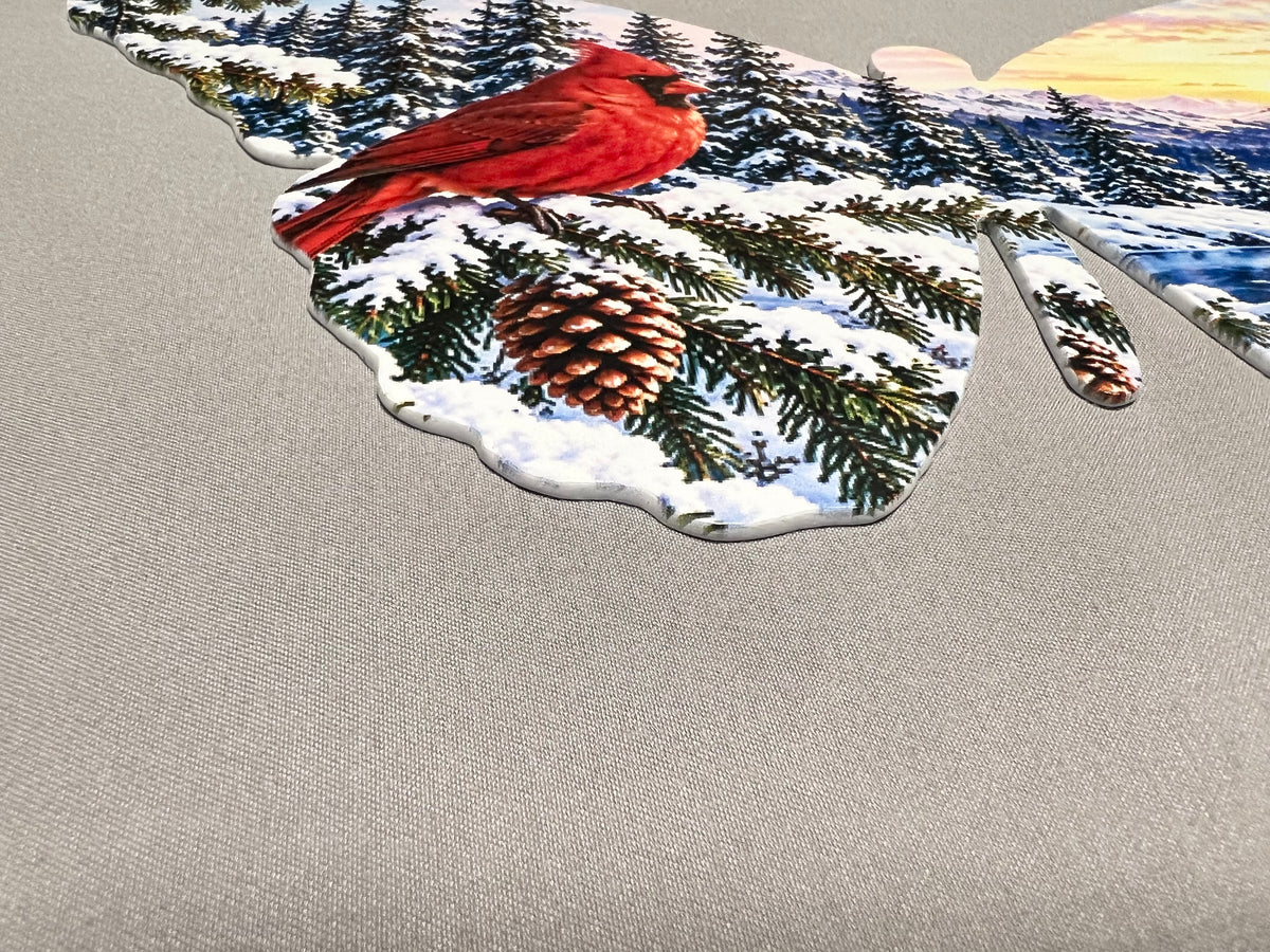 Close-up of the mountain lake and winter sunrise printed on the right wing of the cardinal butterfly wall decor.