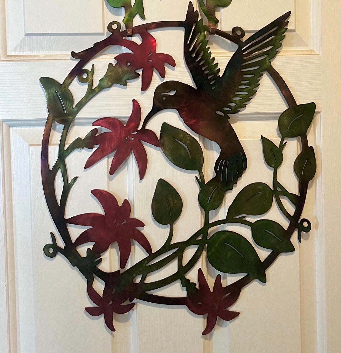 Hummingbird and flowers metal art mounted on a white door with the optional door hanger.