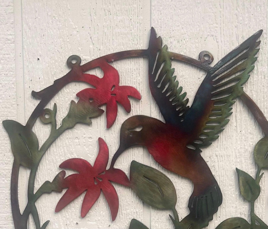 Close-up of hummingbird and flower details with hand-applied multicolor patina.