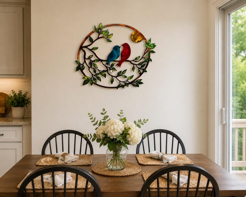 Colorful love birds metal wall art with two birds perched among leafy branches and a sun.