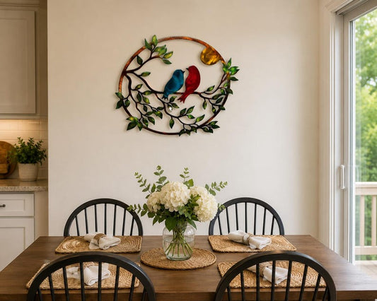 Colorful love birds metal wall art with two birds perched among leafy branches and a sun.