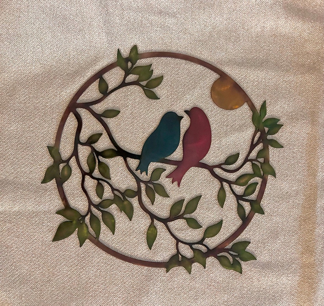 Round love birds metal wall art with hand-applied patina finish and leafy branch design.