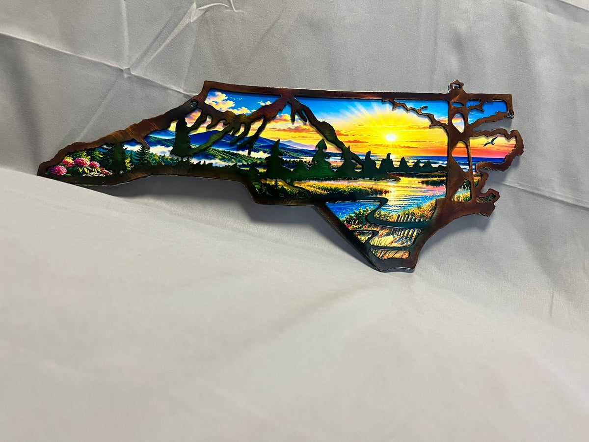 North Carolina layered metal wall art with UV-printed mountain-to-coast sunrise scene and hand-finished steel foreground.
