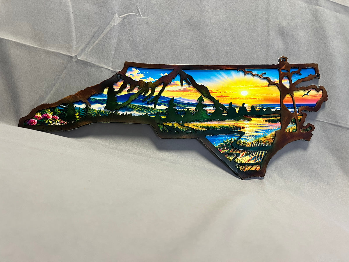 North Carolina layered metal wall art with UV-printed mountain-to-coast sunrise scene and hand-finished steel foreground.