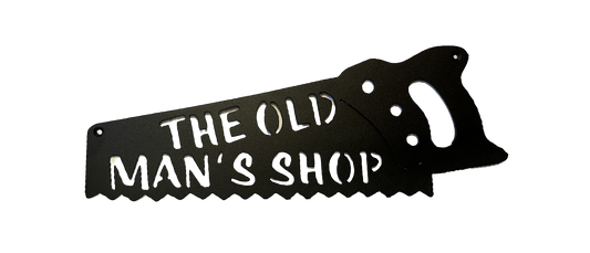 Black metal Old Man's Shop handsaw wall sign shown on a dark background