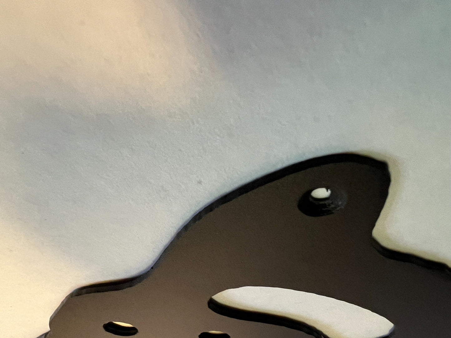 Close-up showing the steel edge and mounting hole of the handsaw sign