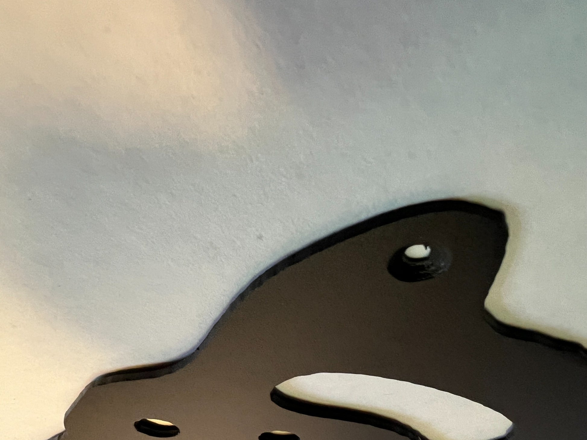 Close-up showing the steel edge and mounting hole of the handsaw sign