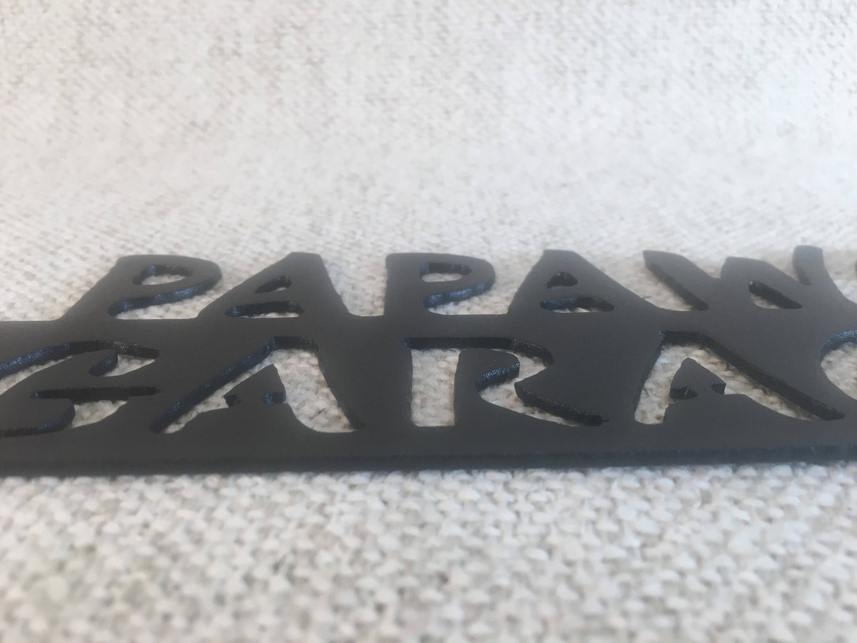 closeup p papaws garage crescent wrench with words cut into the steel