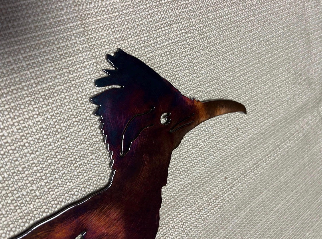 Close-up of the roadrunner metal art head showing crest, eye, beak, and hand-finished patina detail.