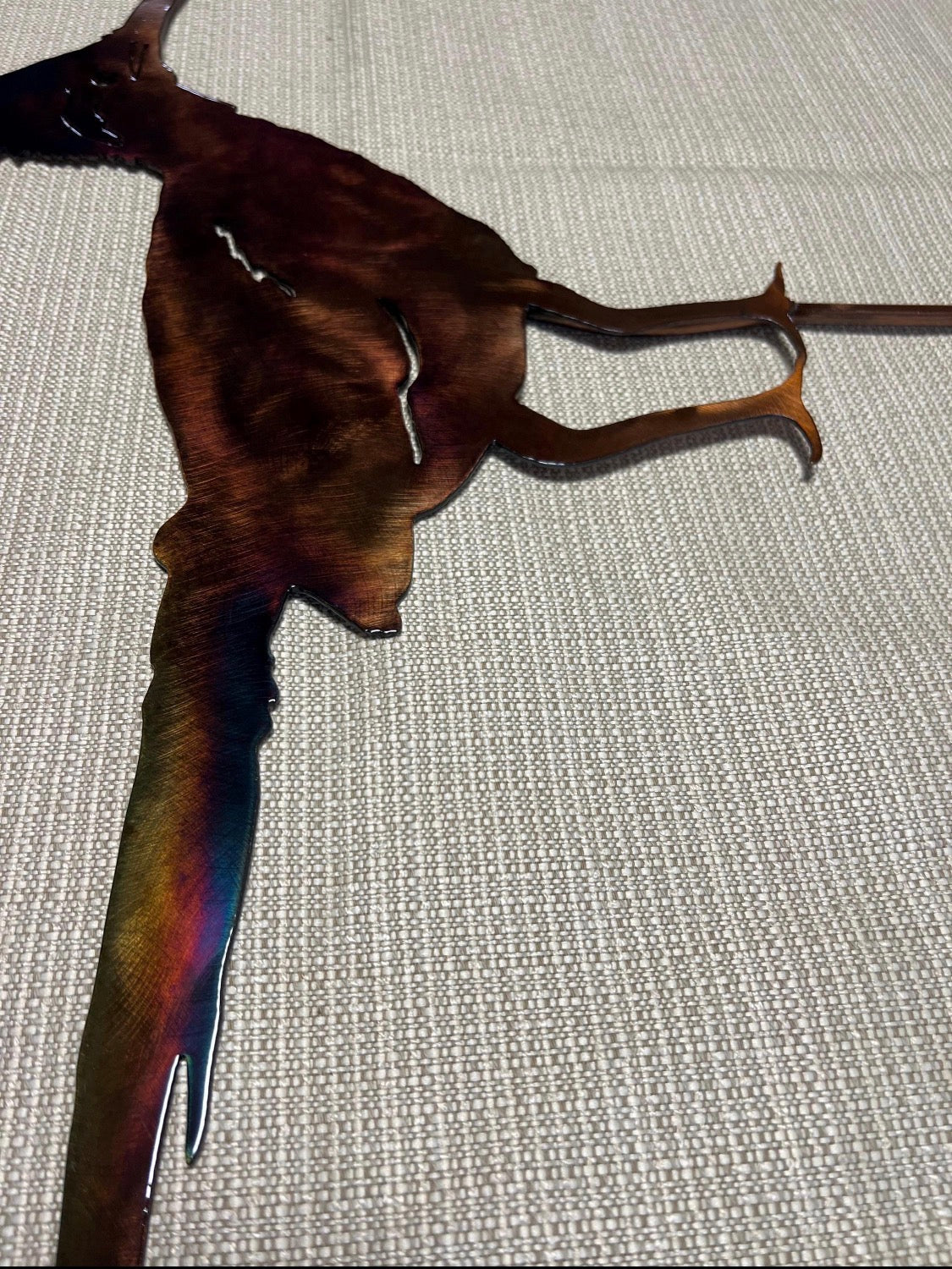 Close-up of the steel roadrunner legs and welded yard stake with hand-finished patina.