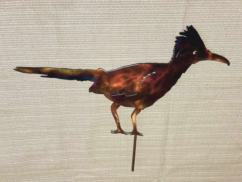 Hand-finished steel roadrunner yard stake with multicolor patina for outdoor garden display.
