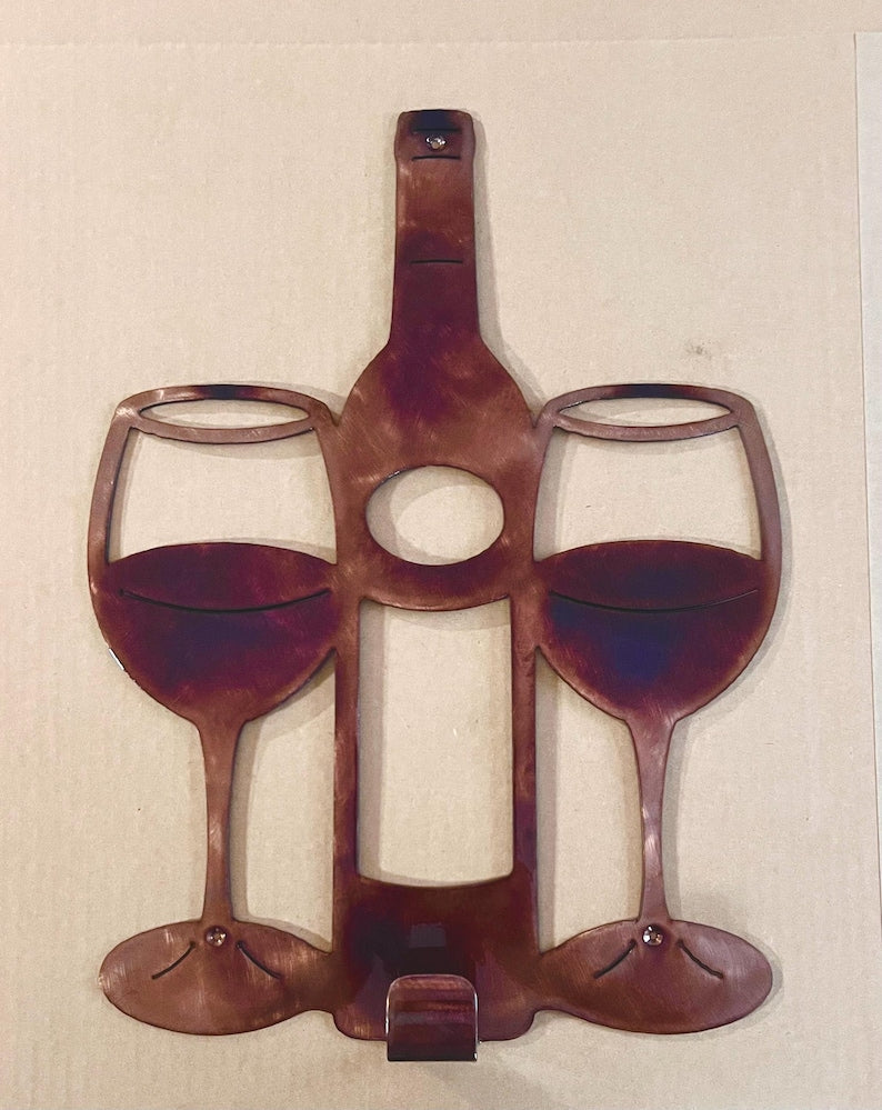 Wine bottle and two wine glasses metal wall art with lower hook for hanging a bar towel.