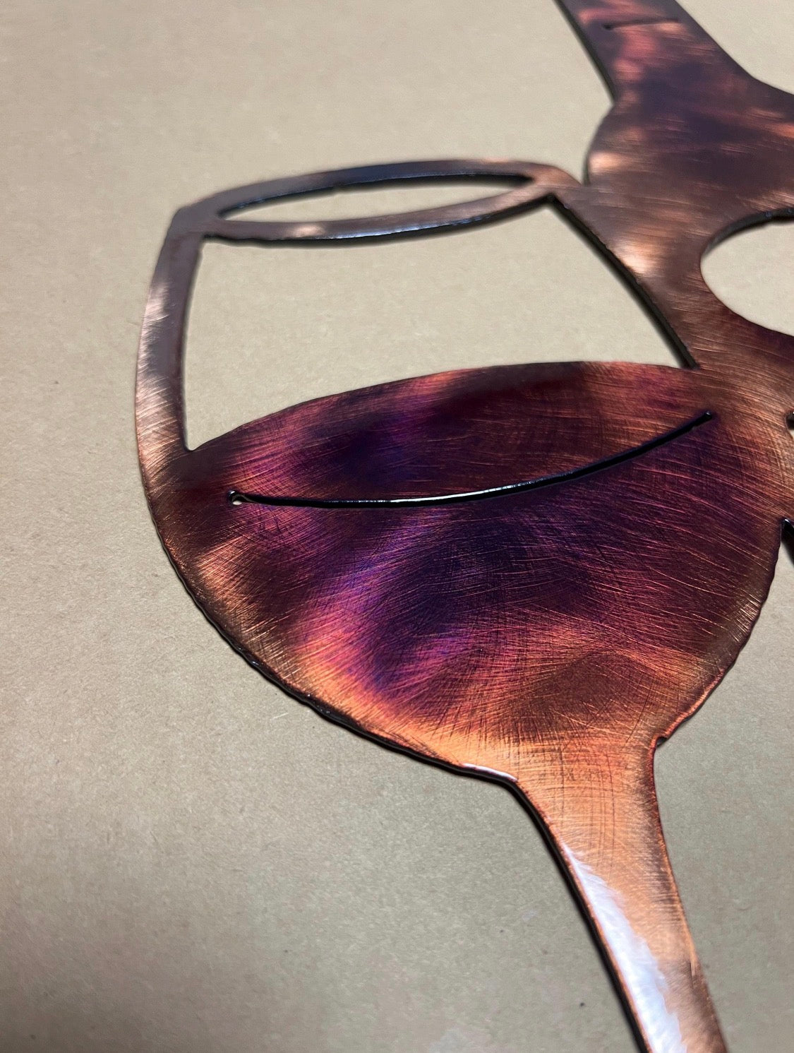 Close-up of the second wine glass showing copper, burgundy, and purple hand-finished patina.